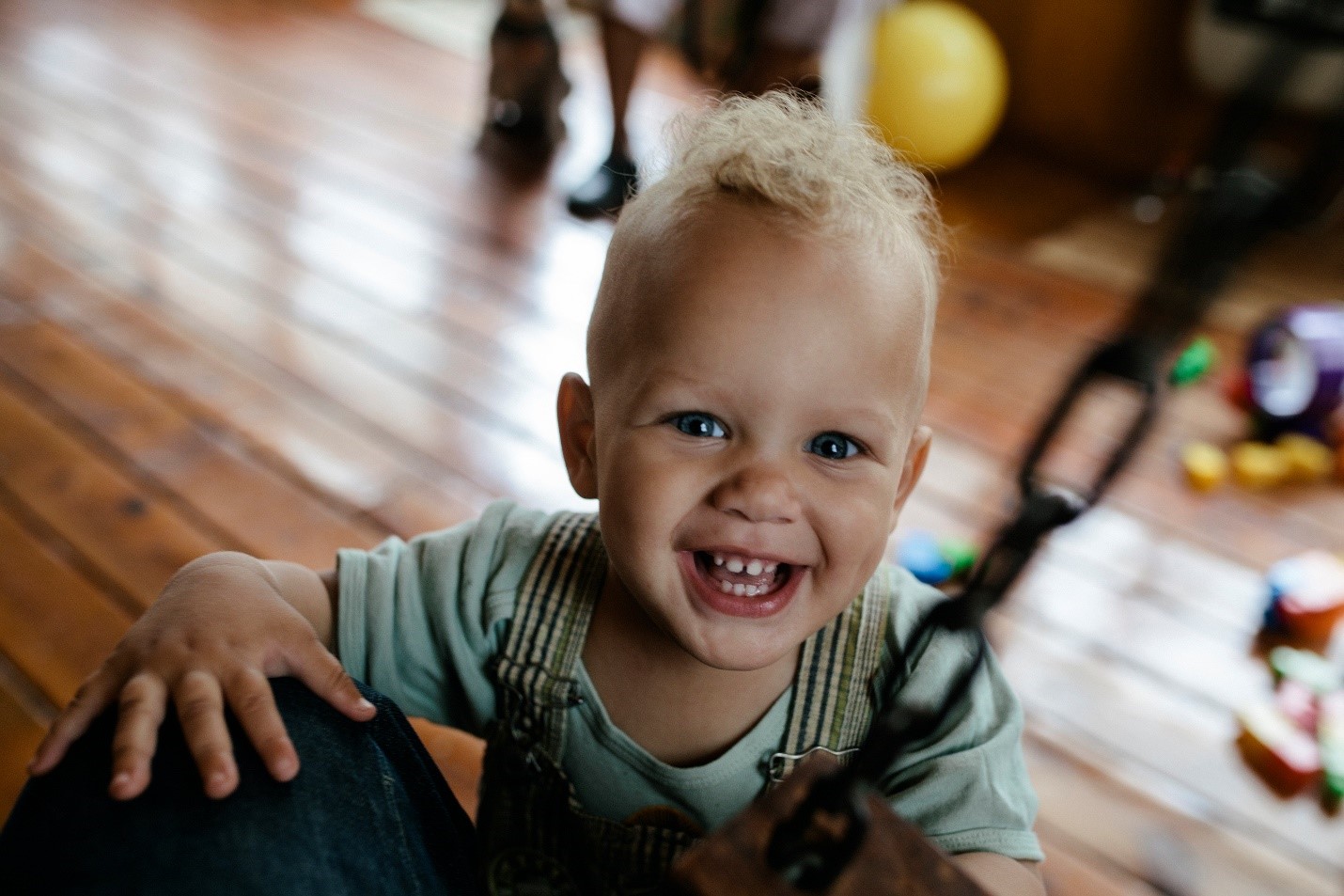 Child Care Transition photo tile with a baby boy smiling. 